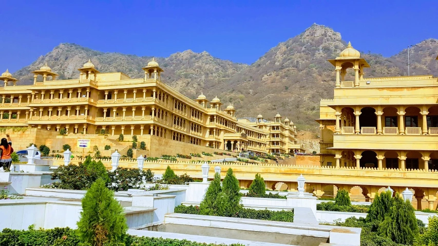 some building with a balcony in front of mountains