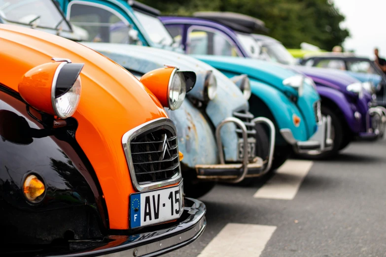 four old fashioned beetle's on display at a car show