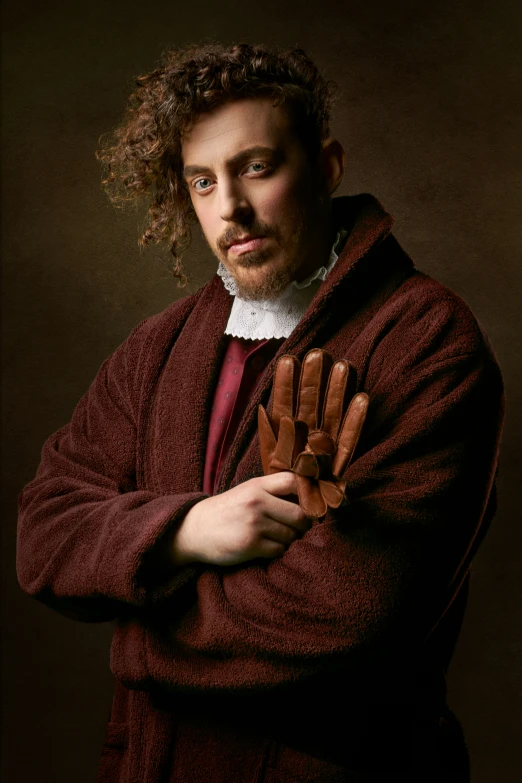 a man standing and holding onto a glove