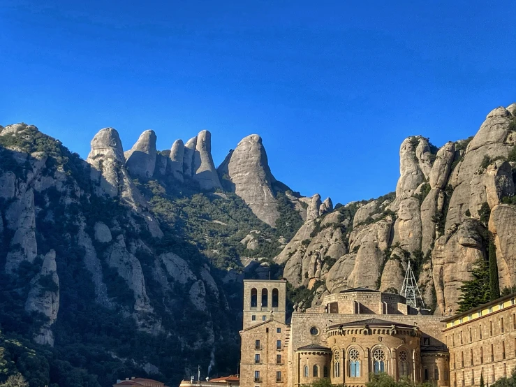 there is a building at the base of a mountain