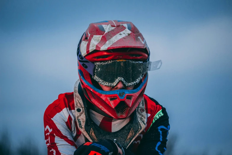a person wearing some red and white helmet holding their skis