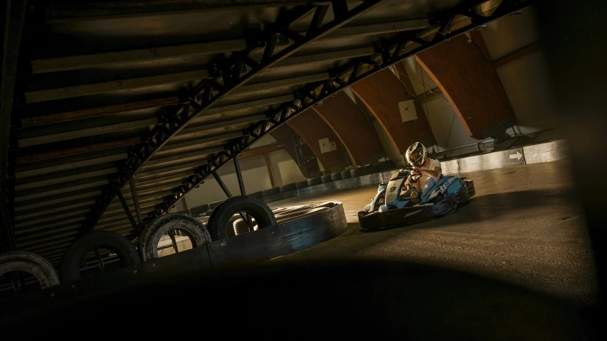 a person riding an indoor kart on a track