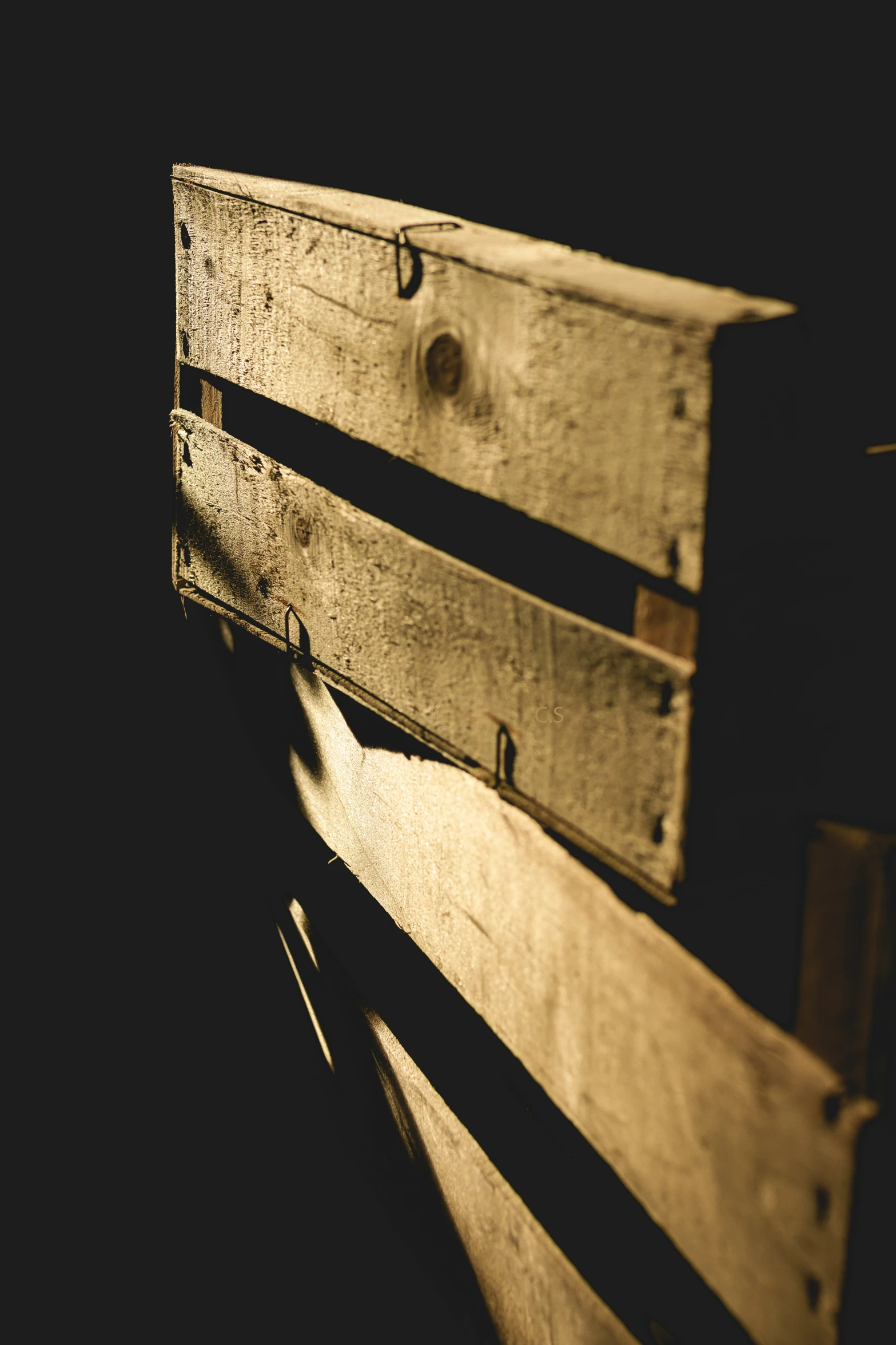 two wooden benches are sitting side by side