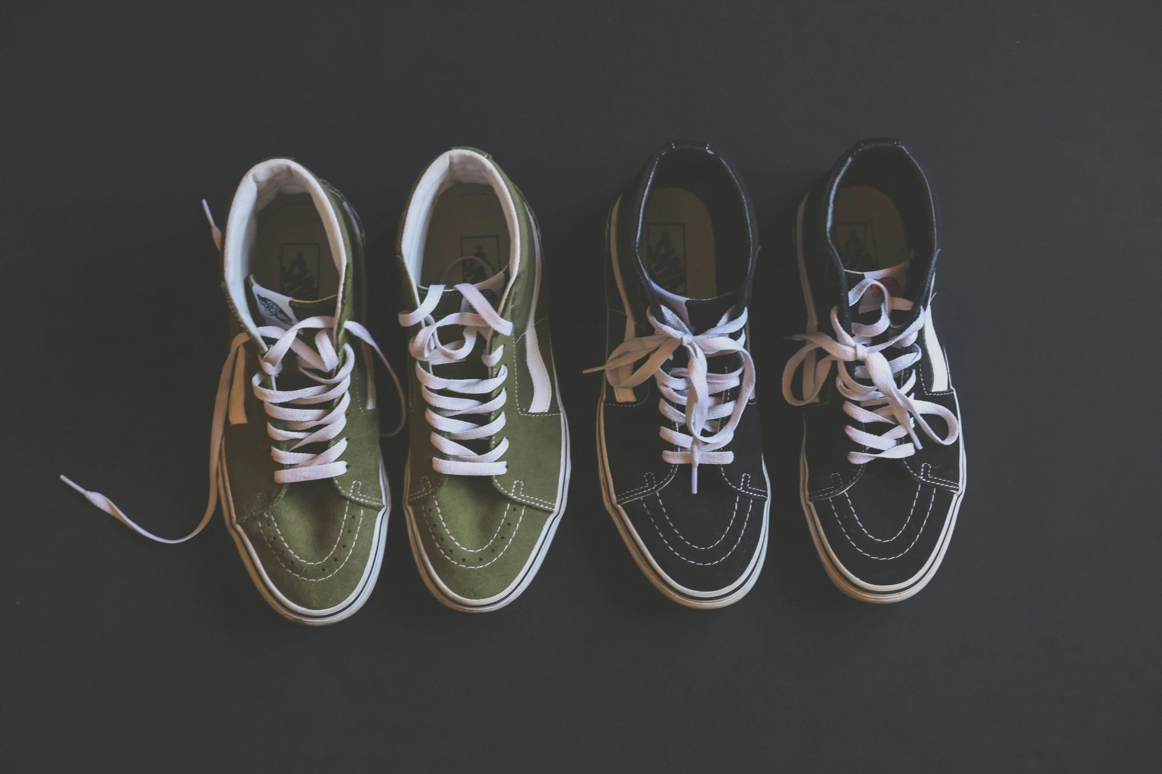 four old - fashioned shoes lined up against a black background