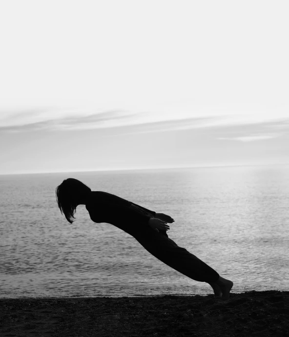 black and white pograph of a person doing a handstand