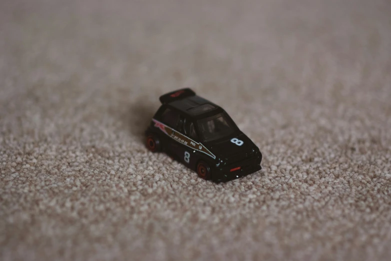a toy car is sitting in the carpet