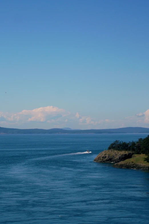 a small boat is out in the open ocean