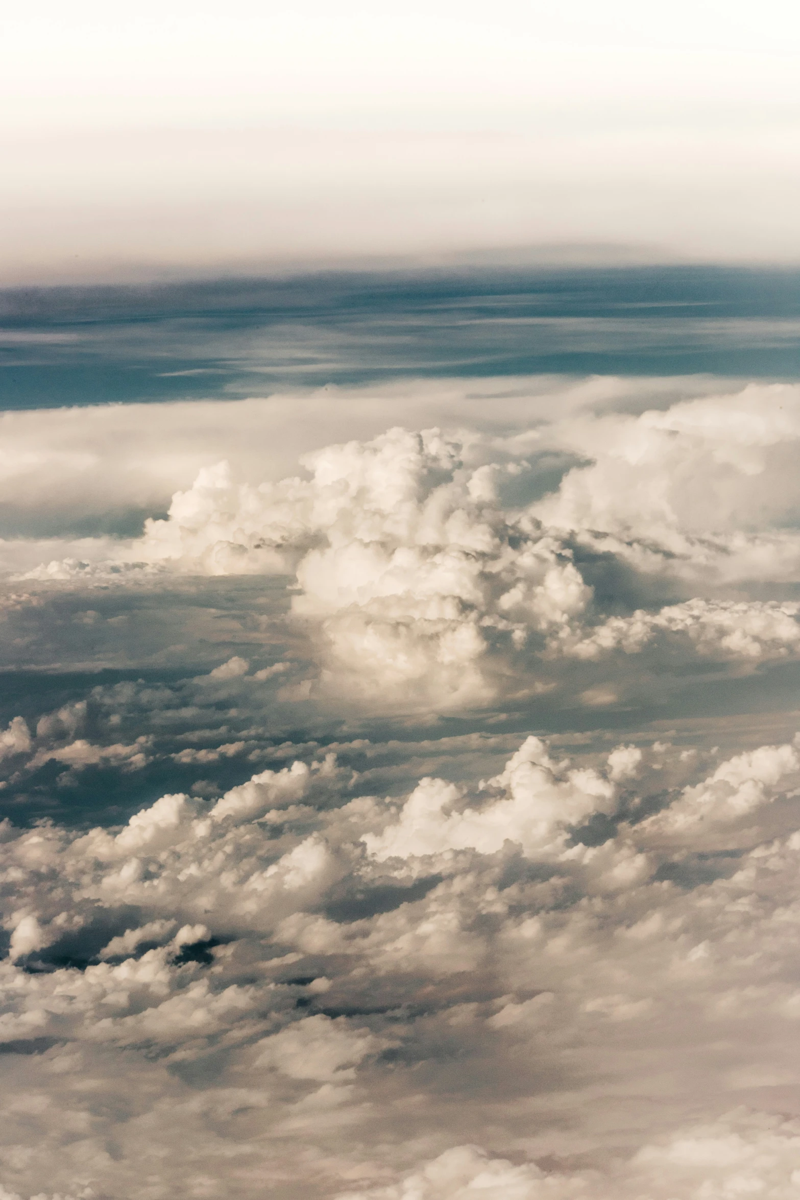 a cloudy view of the ground from above the clouds