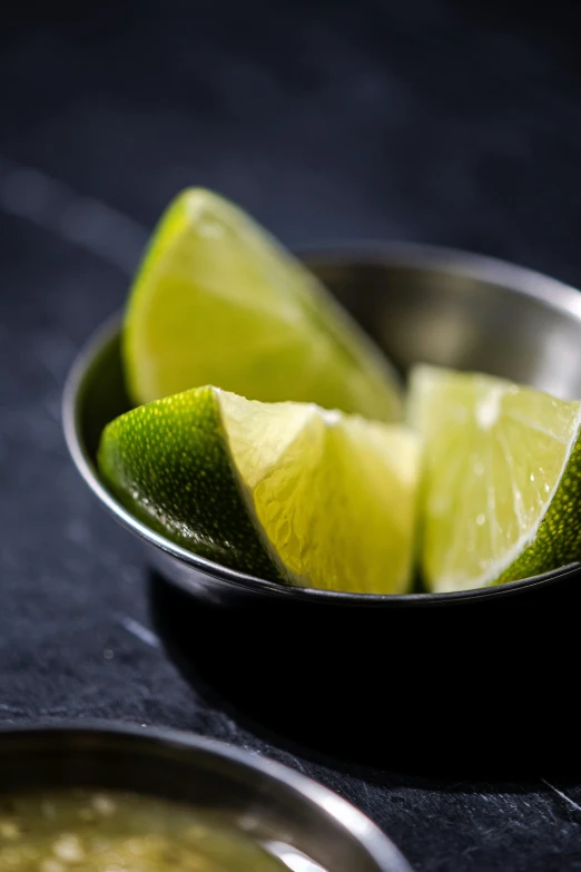 a plate that has some limes and an empty spoon