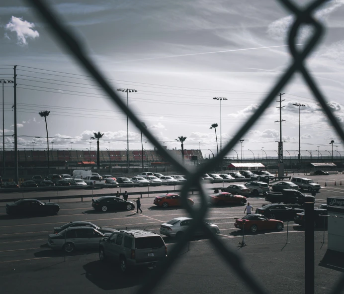 a parking lot with a fence in front of it