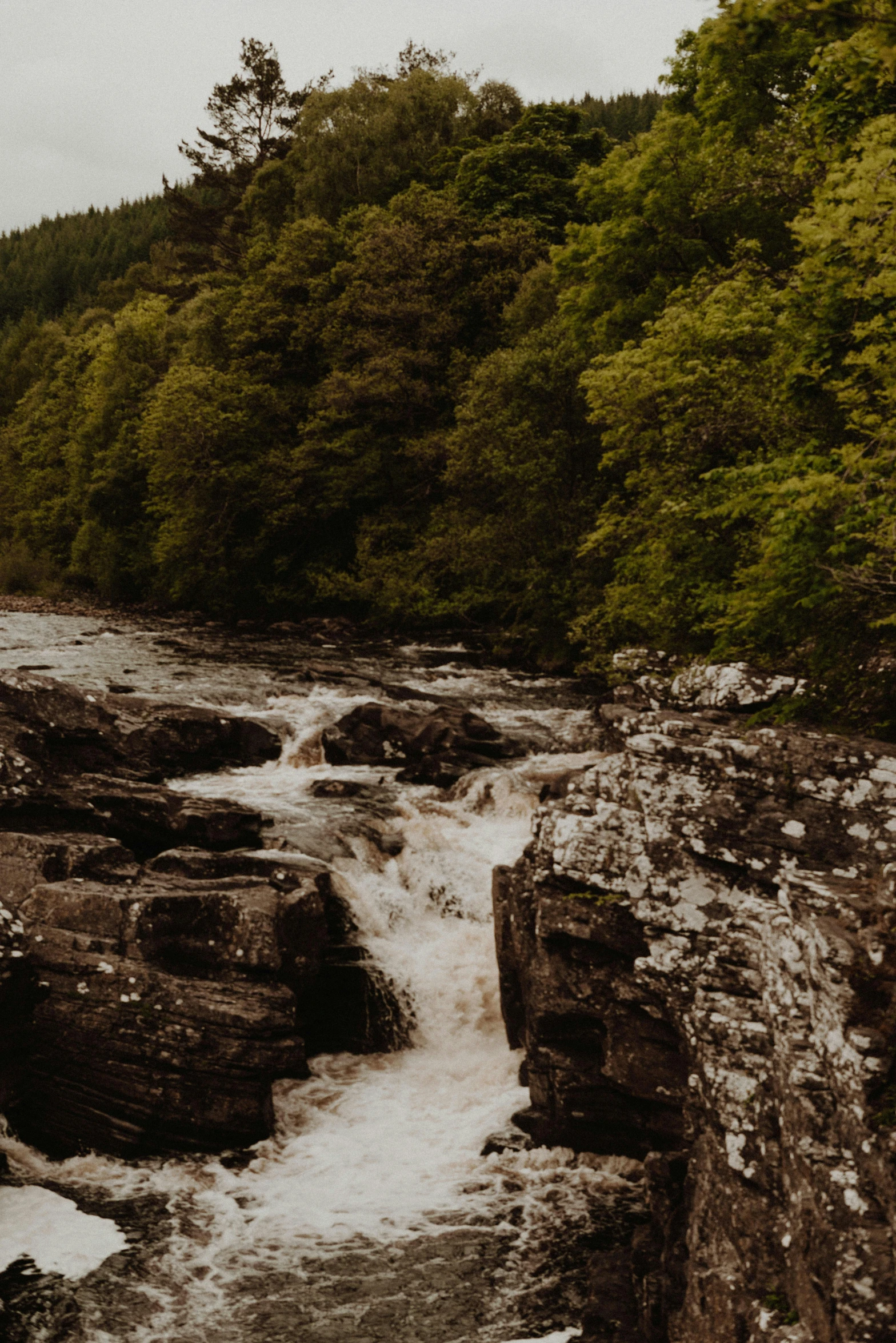 a scenic image of a river flowing through rocks