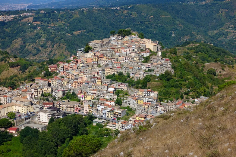 a village in a mountainous valley with tall hills