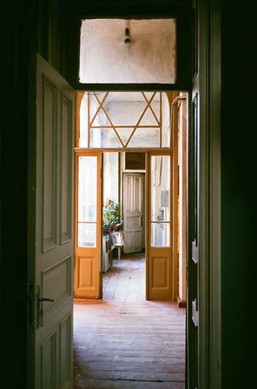 an open door showing two large wood doors