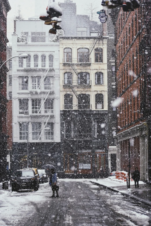 city street with building during a snowfall season