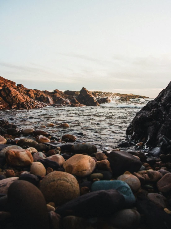 rock beach area with large body of water