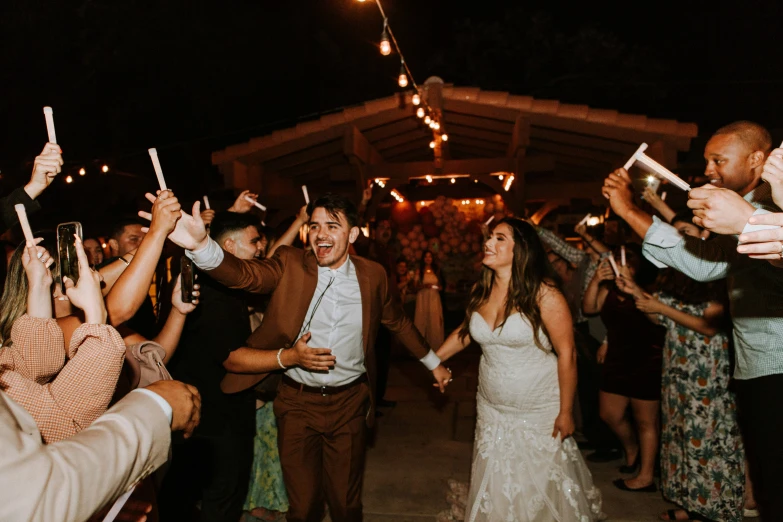 a wedding party and a couple having a night with champagne in front of a crowd