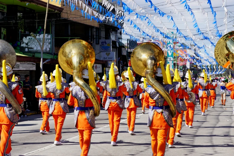 parade participants with metal trumpet instruments lined up in a long line