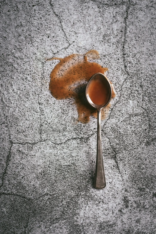 a spoon sitting on top of a dle of liquid