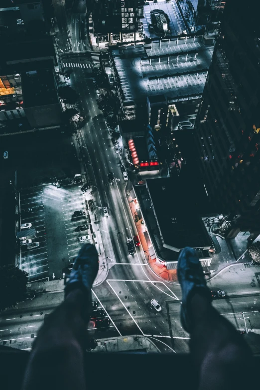 two persons standing on top of a tall building