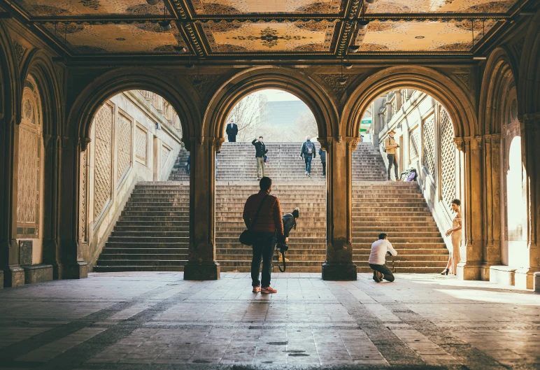 two men walking down a set of stairs in a castle