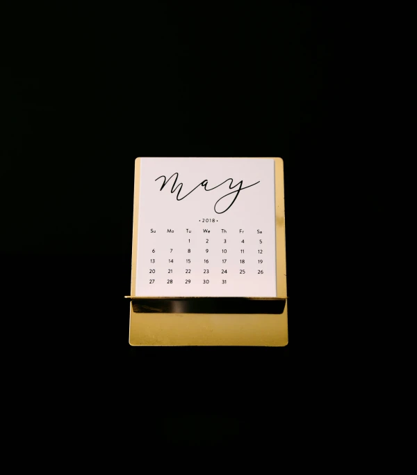 this is a desk calendar in gold and white