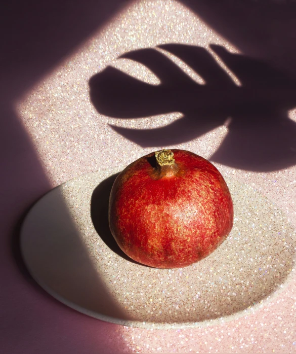 an apple is sitting on the surface of a bowl