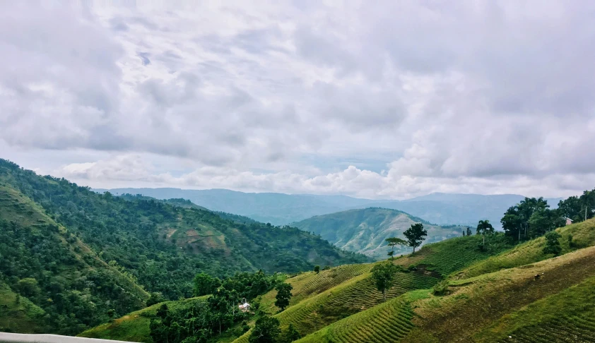 the mountain is very steep and lush on a cloudy day