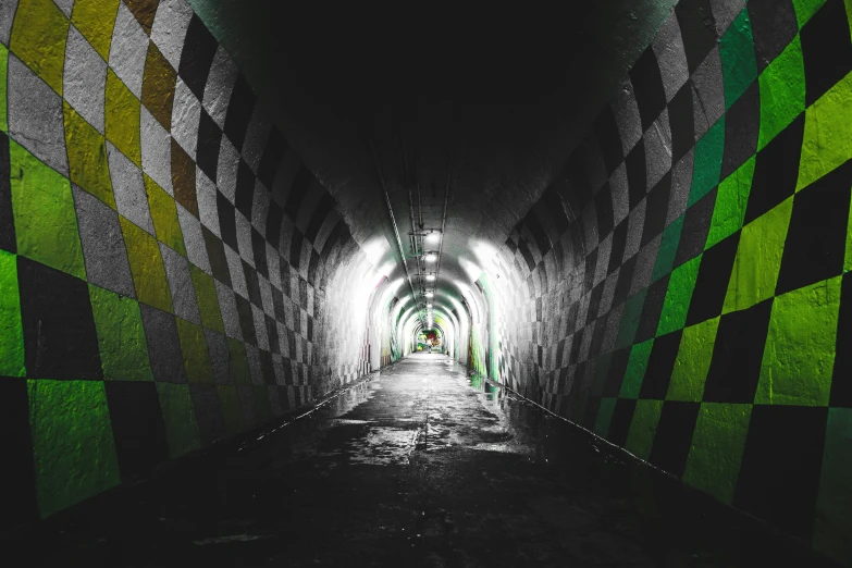 a brightly colored tunnel with light coming through it