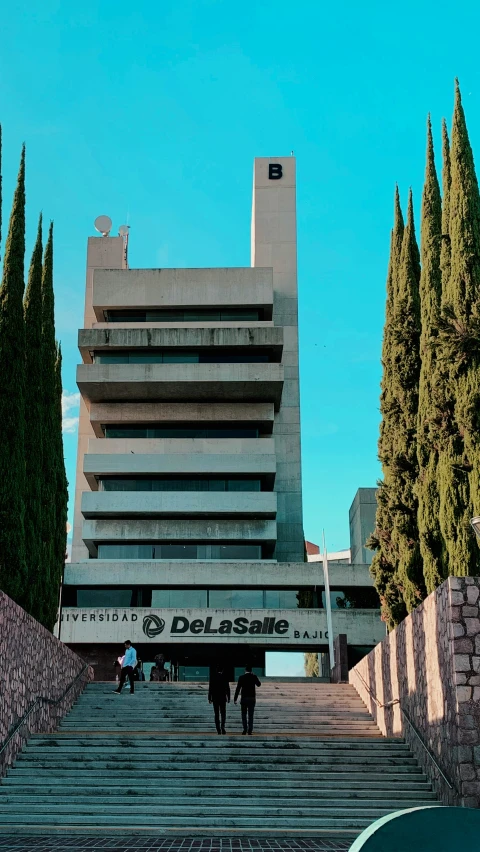 the stairs lead down to a very tall building