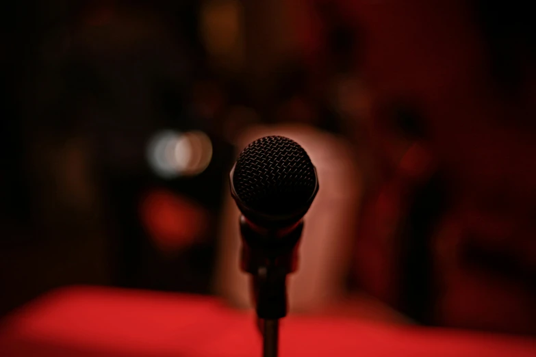 a black microphone is sitting on a red surface