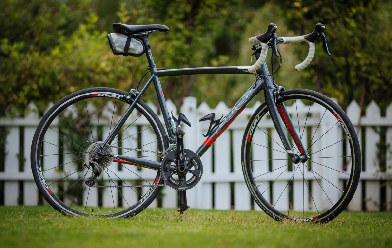 a bike parked on top of a green grass field