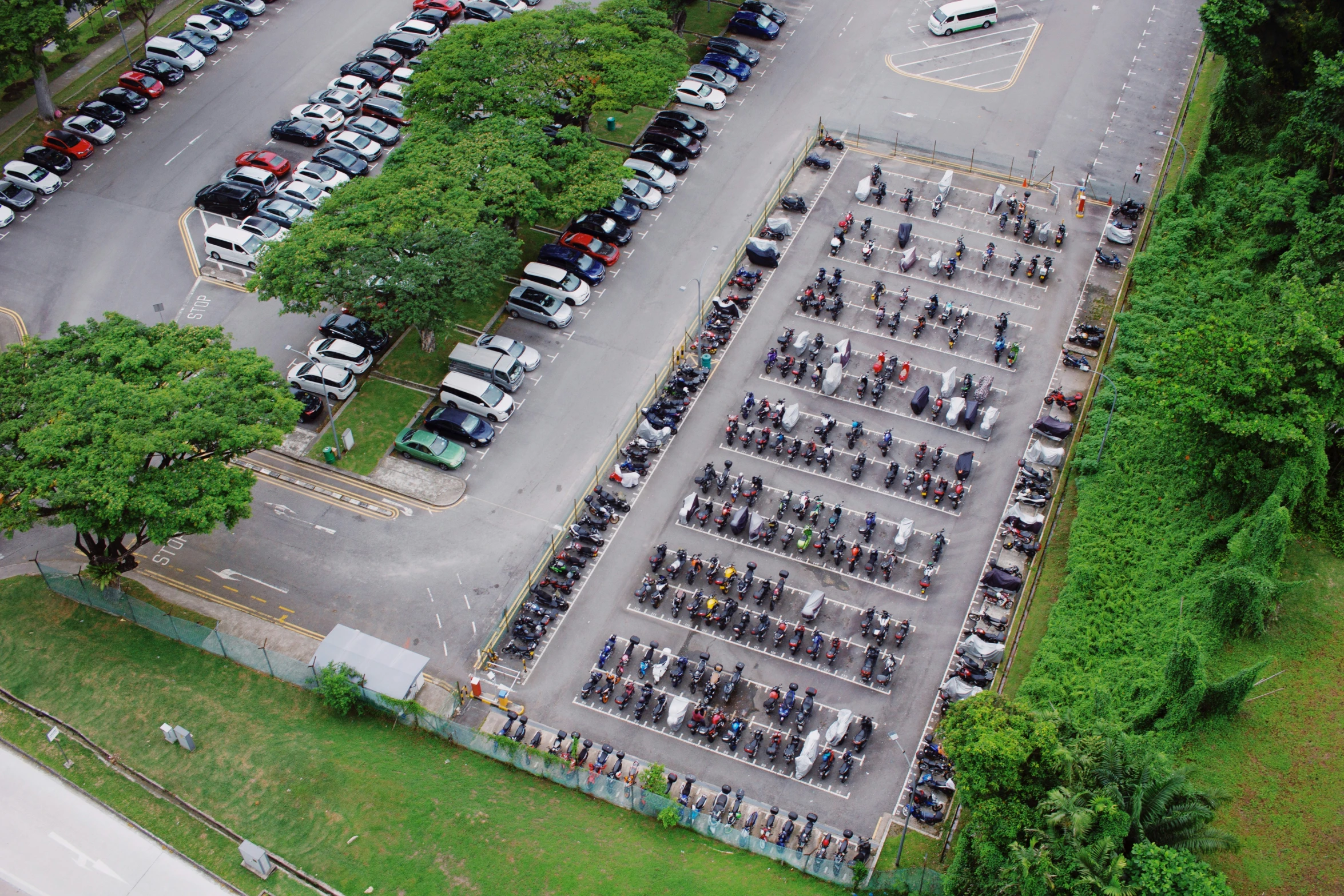 an aerial view of people standing around parking lot