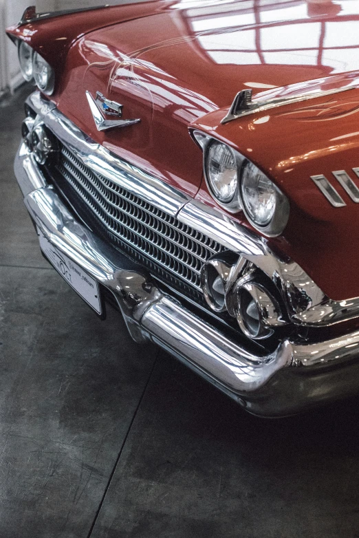 the front end of a red old style car