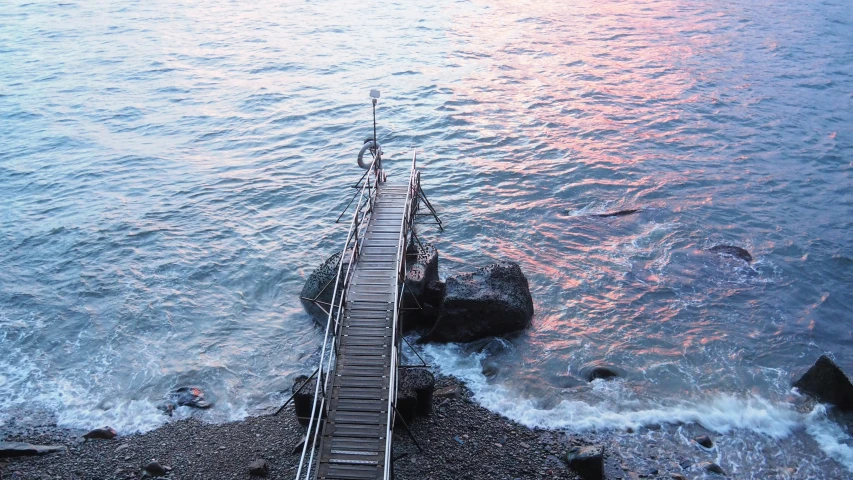 steps lead to a beach, and an ocean is shown