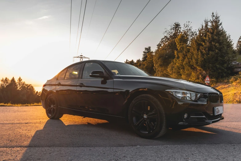 a car parked on the side of the road in front of power lines