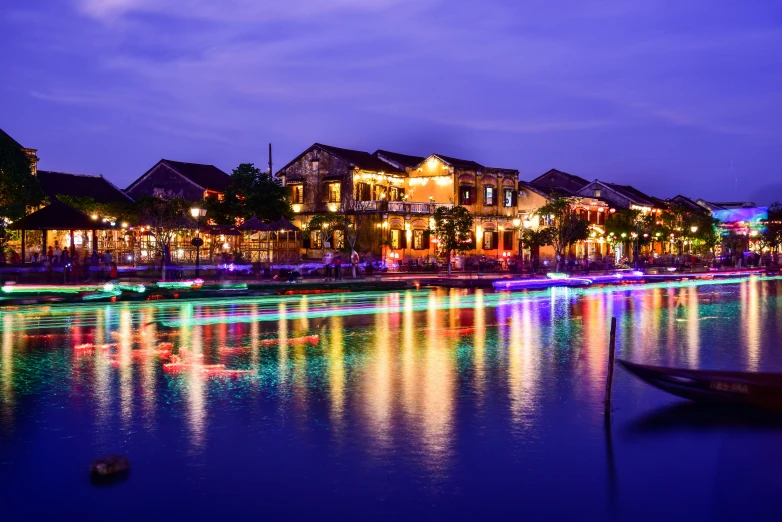 there is a lit up canal at night