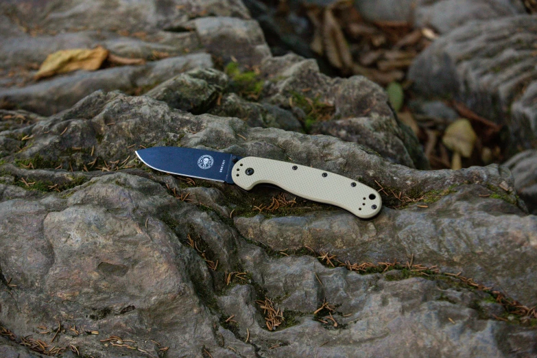 the small knife is on top of some rocks