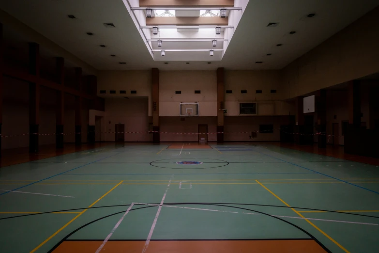 a basketball court with multiple lines on the floor and two lights on the ceiling