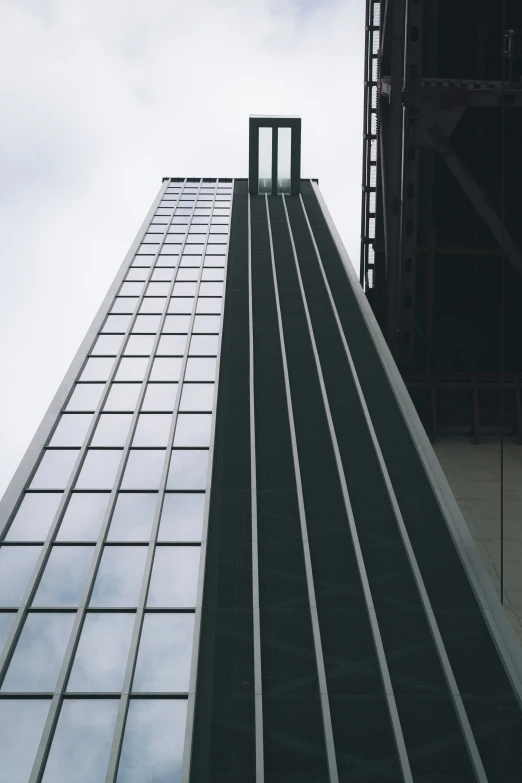 a building with glass windows with the sky in the background