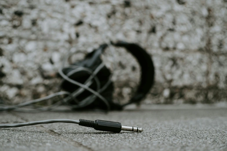 headphones resting on the ground near a wall