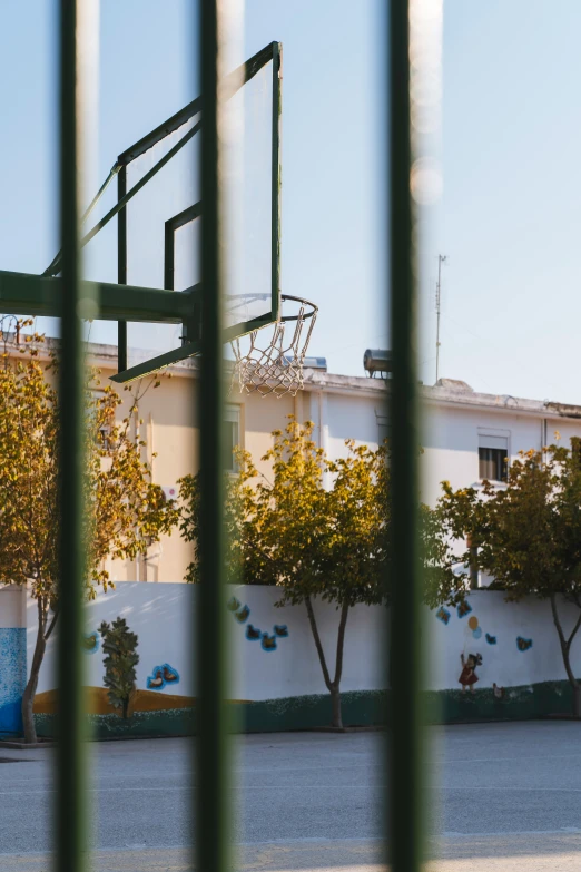 view out the window of an apartment building with basketball hoop in foreground