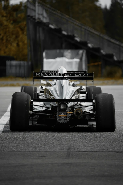 a silver car sitting on top of a race track