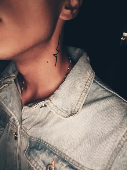 the woman's neck and neck tattoo features a black outline of a bird