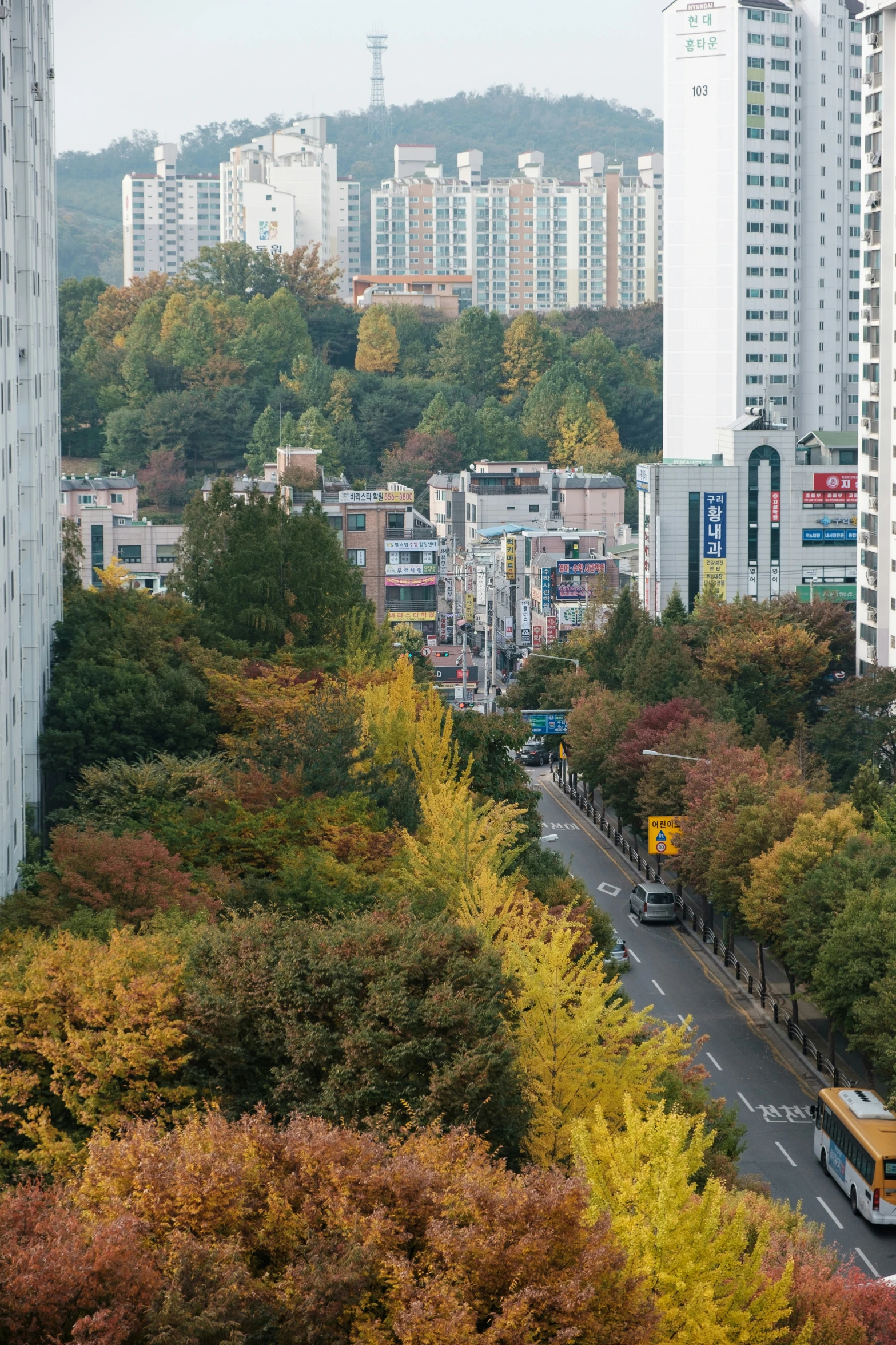 a long road with some very tall buildings in the back