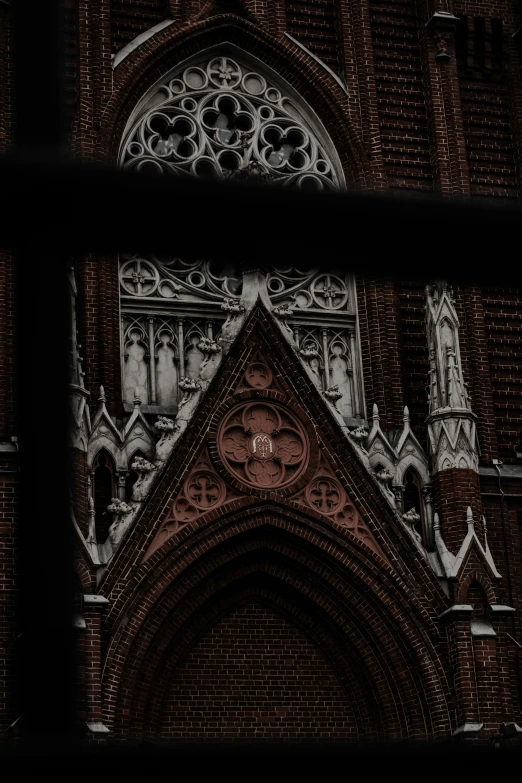 an old church with gothic design as seen through a window