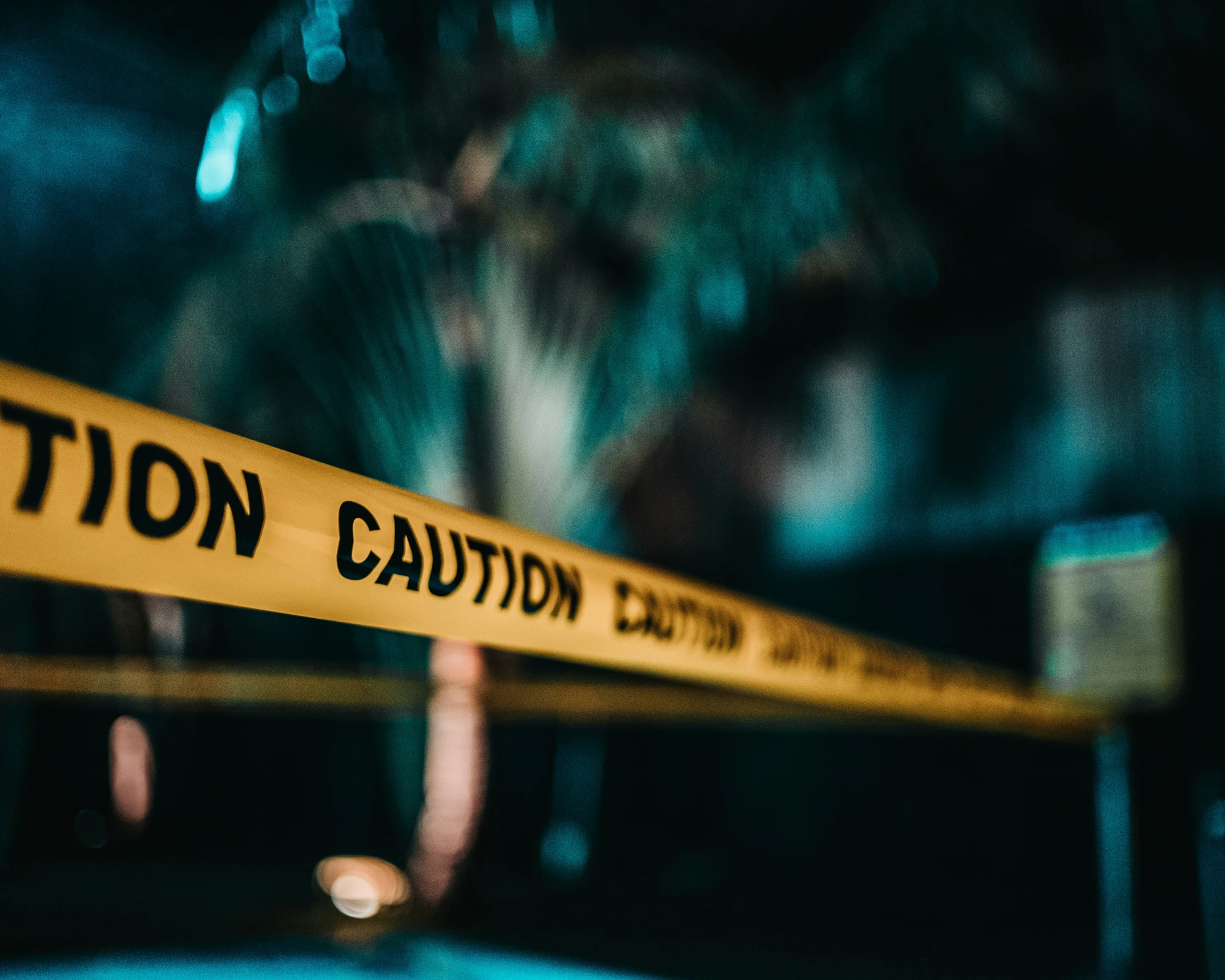 the caution line of a crime scene in focus