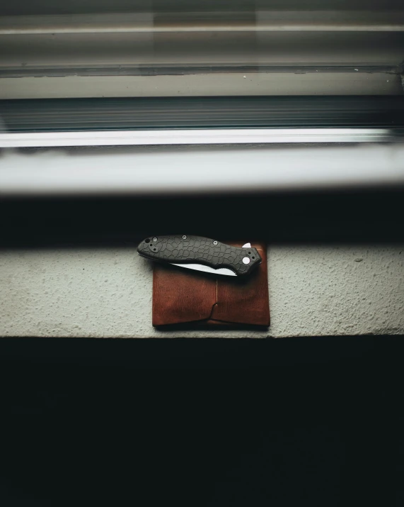 an object lying on top of a piece of brown leather