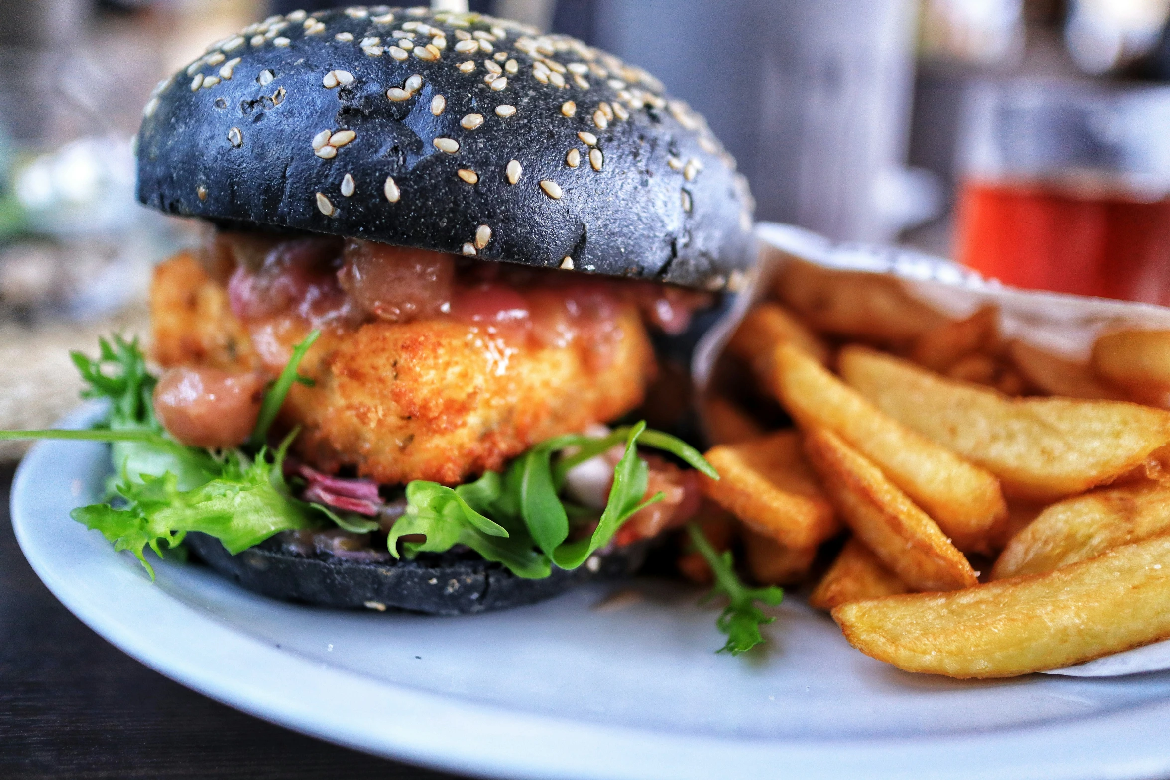 a burger, fries and drink sitting on a table