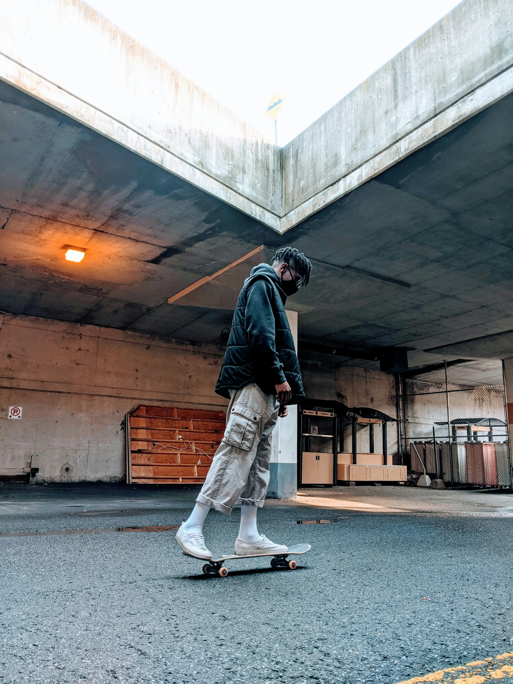 the man is riding his skateboard near a concrete building