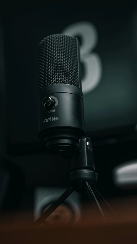 a microphone on top of a brown desk